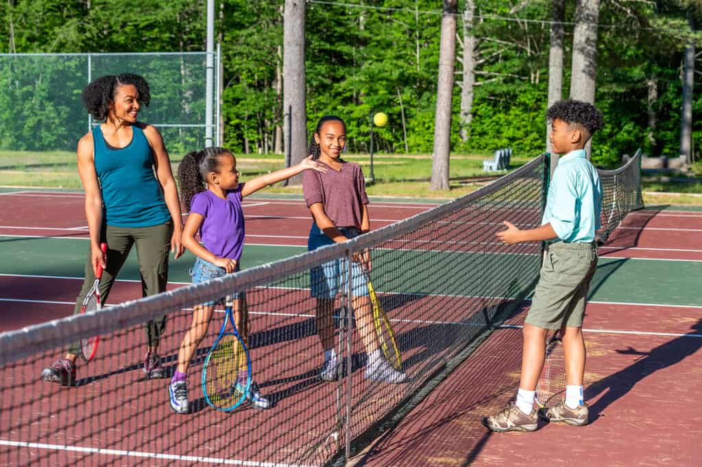 family playing tennis
