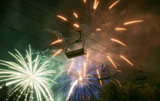Chairlift with fireworks in background