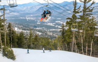 people on a chair lift at attitash